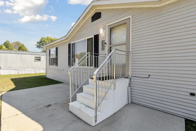 a view of backyard of a house with wooden deck