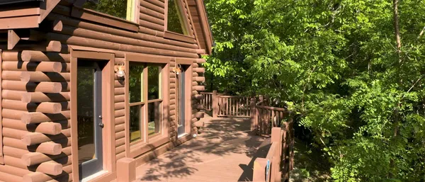 a view of a porch with wooden floor and fence
