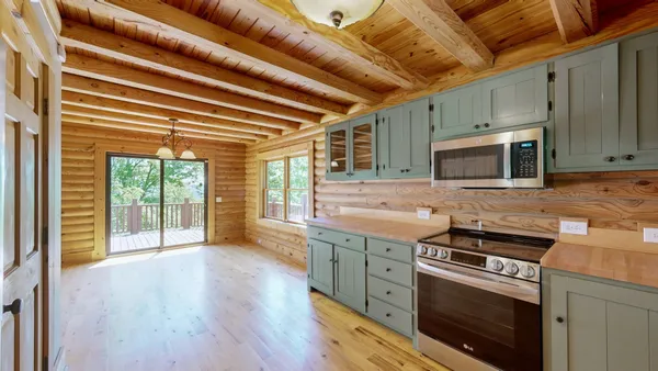 a view of room with wooden floor and a floor to ceiling window