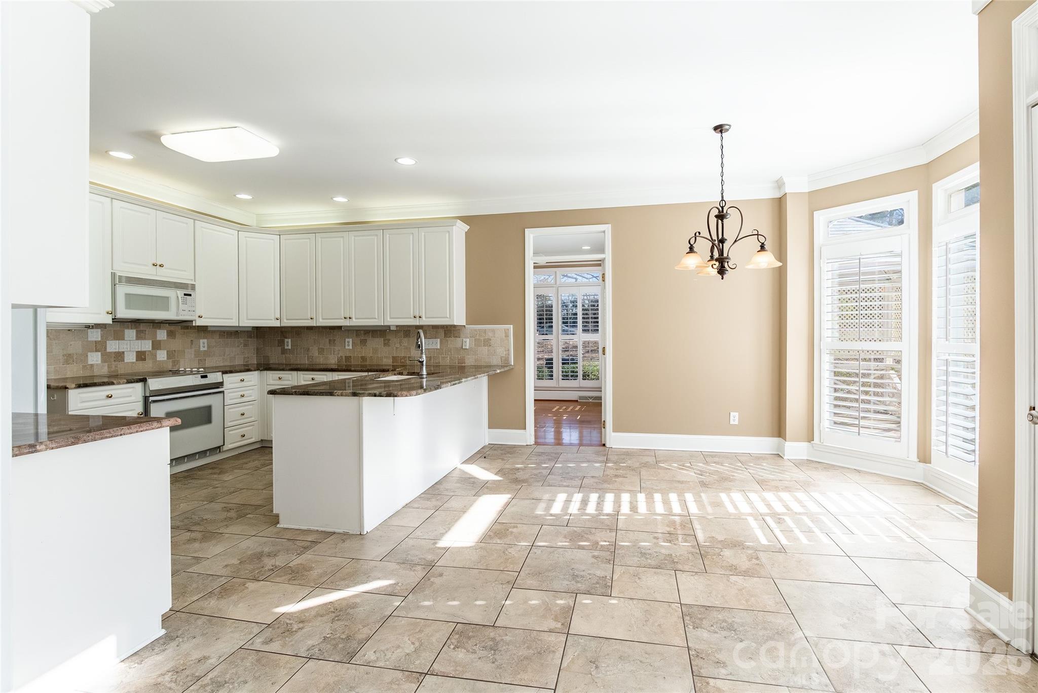 1909 Malvern Road Rock Hill, SC 29732 - Photo 11 of 40 a kitchen with stainless steel appliances granite countertop a stove a sink and a refrigerator