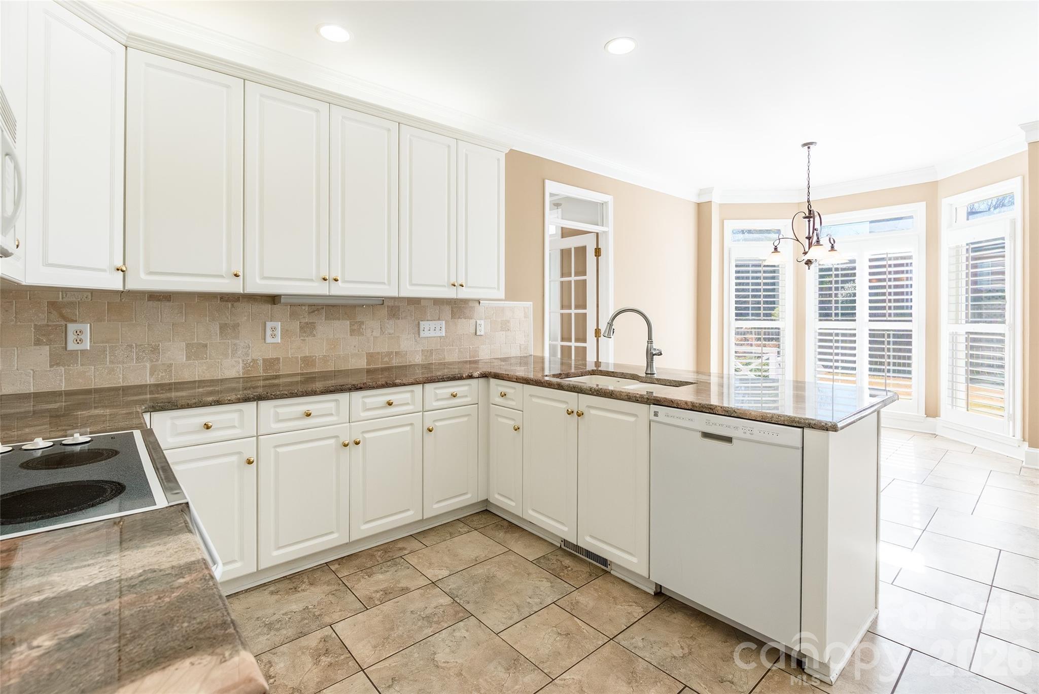 1909 Malvern Road Rock Hill, SC 29732 - Photo 15 of 40 a kitchen with granite countertop white cabinets and white appliances
