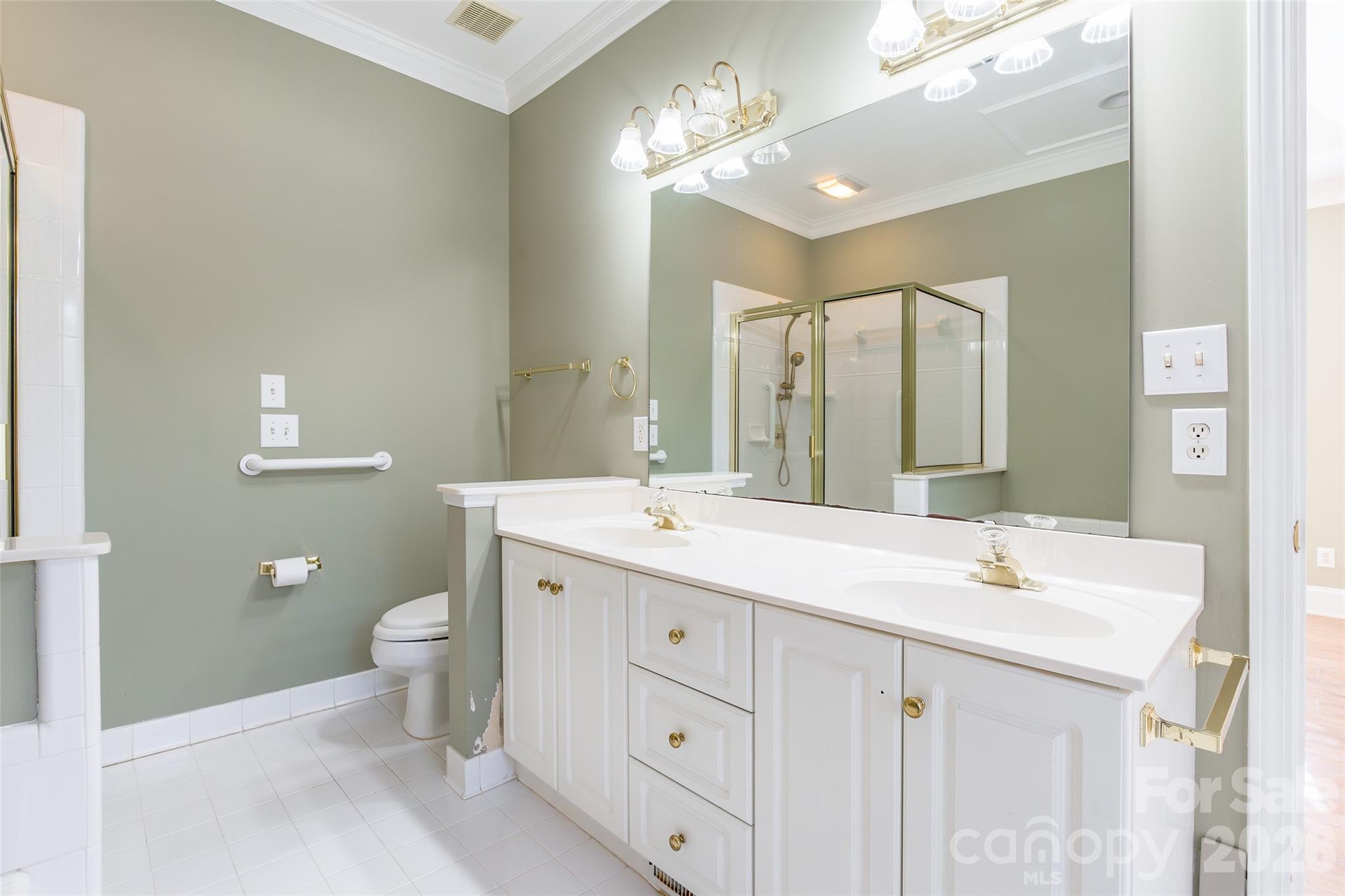 1909 Malvern Road Rock Hill, SC 29732 - Photo 23 of 40 a bathroom with a double vanity sink toilet and a mirror