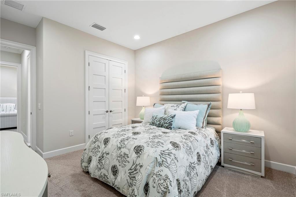 8795 Calypso Court Naples, FL 34113 - Photo 18 of 49 a bedroom with a bed and a window