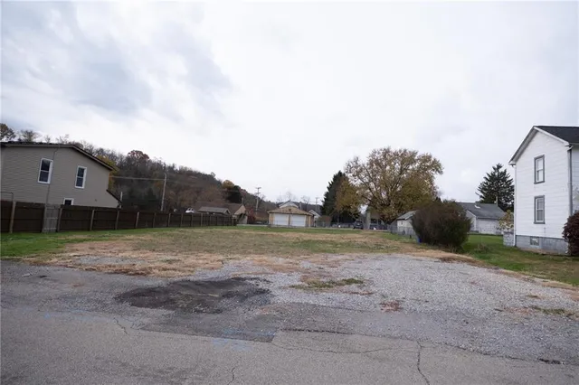 a backyard of a house with wooden fence