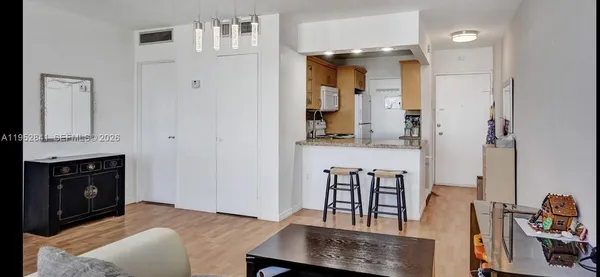 a bedroom with furniture and wooden floor