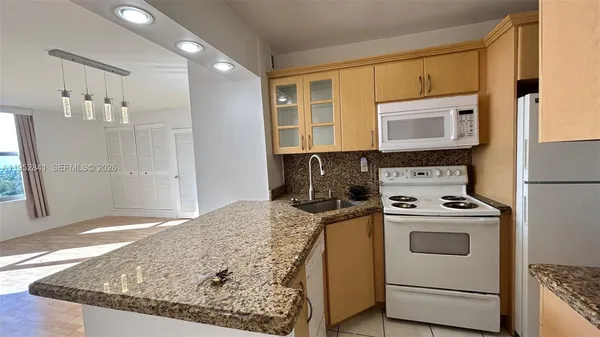 a kitchen with a stove a sink and a microwave