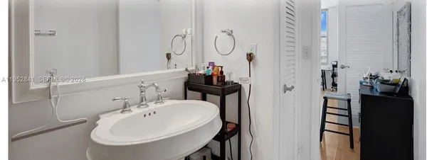 a bathroom with a sink and mirror