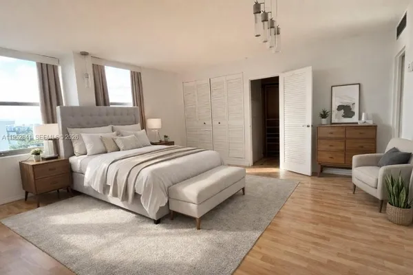 a spacious bedroom with a bed and a couch