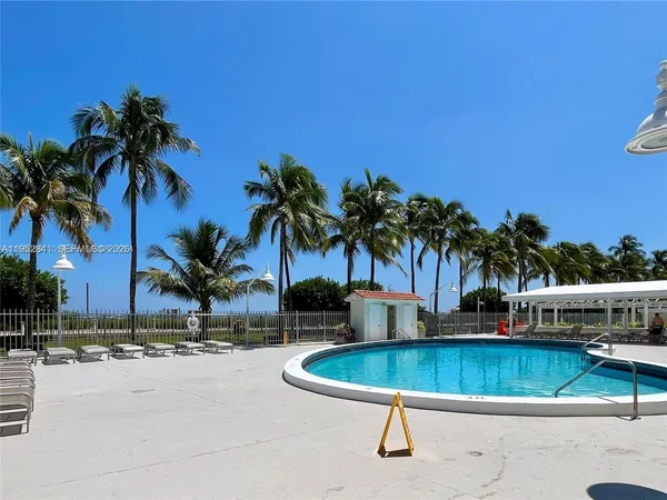 a swimming pool with outdoor seating