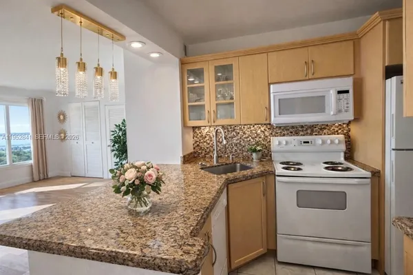 a view of kitchen with stove top oven and cabinets