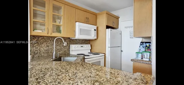 a kitchen with a refrigerator and a stove