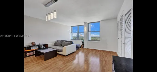 a living room with furniture and a wooden floor