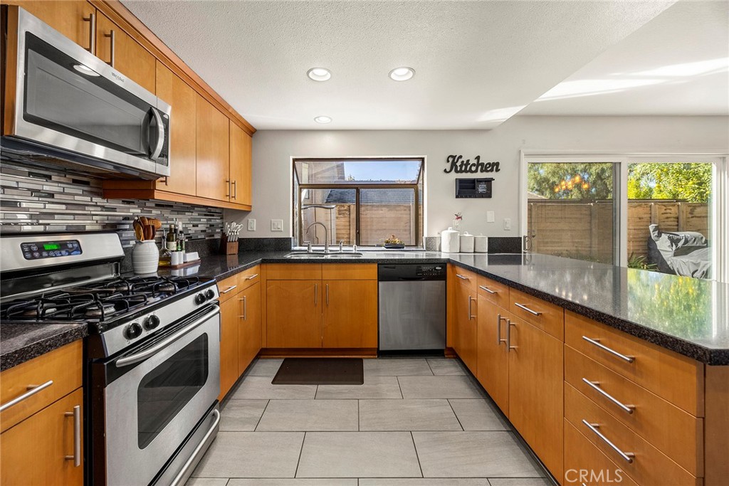 2027 Cobblefield Way Glendora, CA 91740 - Photo 12 of 34 a kitchen with stainless steel appliances granite countertop a stove a sink and a microwave