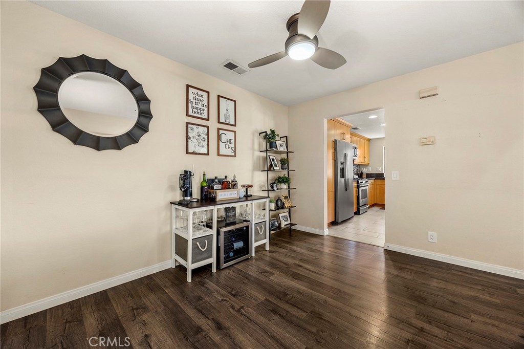 2027 Cobblefield Way Glendora, CA 91740 - Photo 9 of 34 a view of a livingroom and a kitchen with furniture wooden floor and a ceiling fan