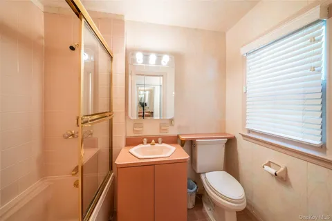 a bathroom with a toilet sink shower and mirror