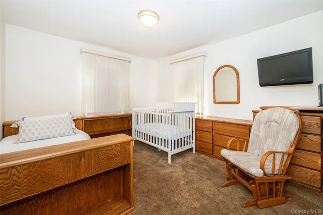 a bedroom with furniture and a flat screen tv