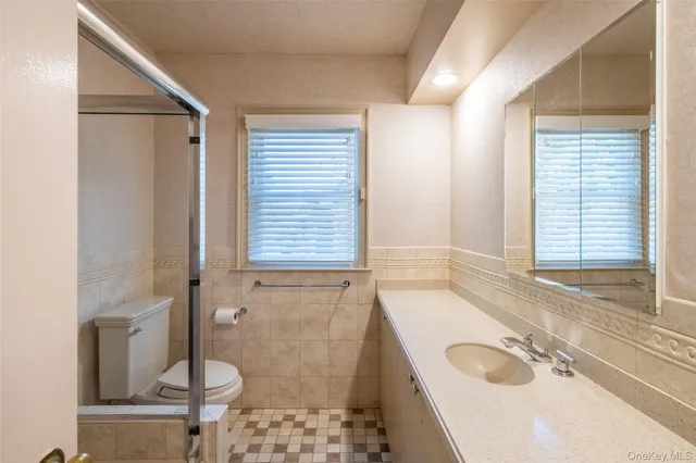 a bathroom with a sink a toilet and tub