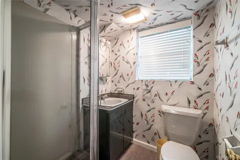 a bathroom with a sink a toilet and shower curtain