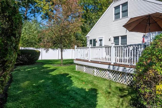 a view of a house with a yard and a patio