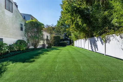 a view of a backyard with large trees