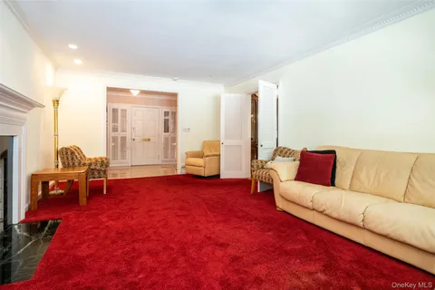 a living room with furniture and a dining table
