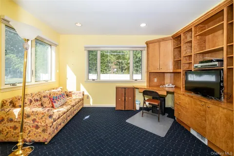 a bedroom with furniture and a flat screen tv