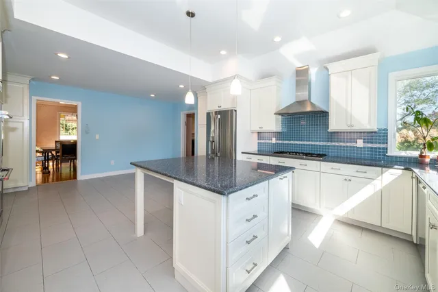 a kitchen with stainless steel appliances granite countertop a sink counter space and cabinets