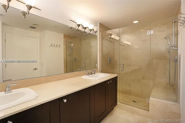 a bathroom with a sink double vanity and a mirror