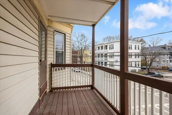 a view of a balcony with wooden floor