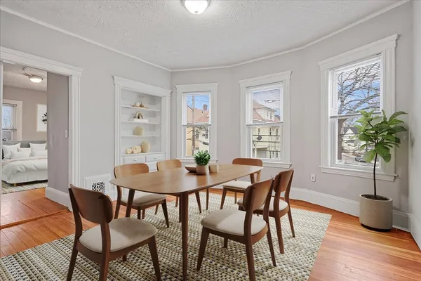 a view of a dining room with furniture window and wooden floor