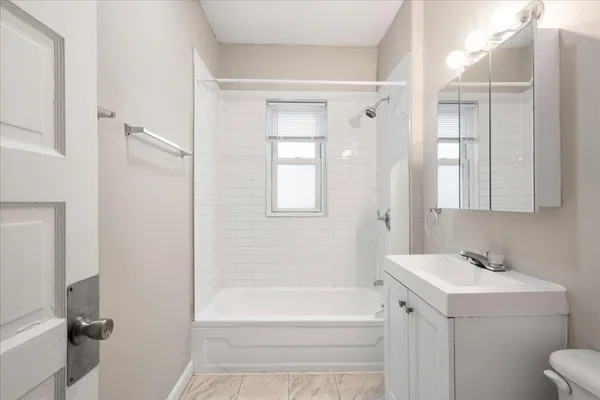 a bathroom with a bathtub a sink and a mirror