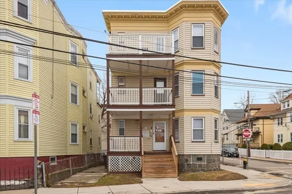 a front view of a residential apartment building with a yard