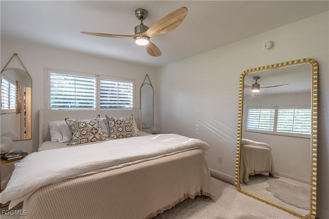 503 Broad Avenue South, Unit 503 Naples, FL 34102 - Photo 12 of 20 a bedroom with a bed and a window