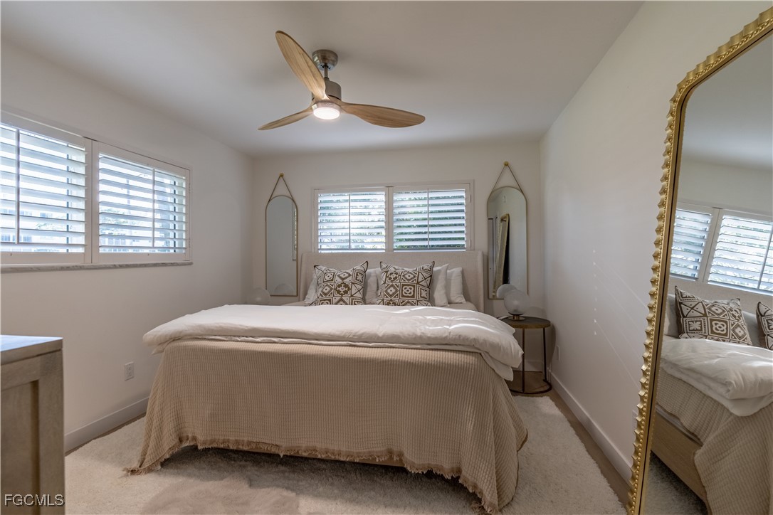 503 Broad Avenue South, Unit 503 Naples, FL 34102 - Photo 18 of 20 a bedroom with a bed and window