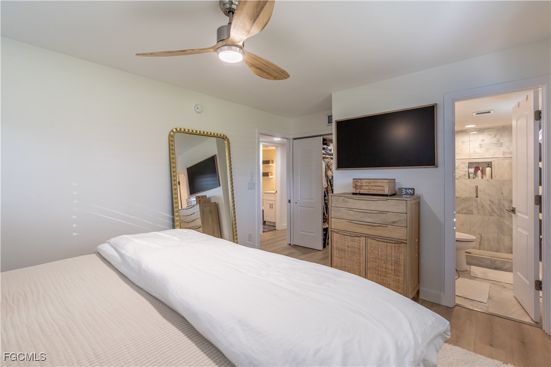 503 Broad Avenue South, Unit 503 Naples, FL 34102 - Photo 20 of 20 a bedroom with a bed and a flat screen tv