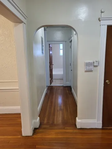 a view of a hallway with wooden floor