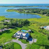 an aerial view of a houses with a lake view