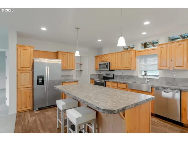 a bathroom with a granite countertop sink and a large mirror
