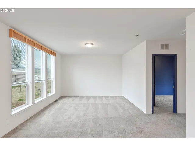 a view of a living room a kitchen with a large window