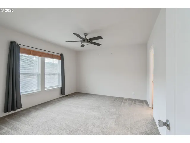 a view interior of a house with a ceiling fan and wooden floor