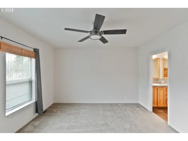 a bathroom with a granite countertop sink mirror and a shower