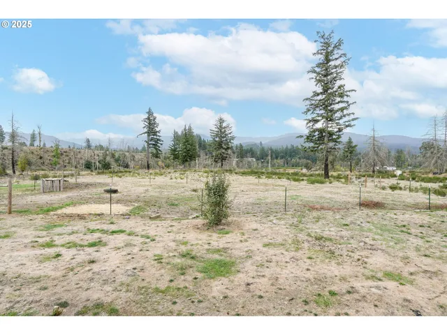 a view of a house with a yard and sitting area