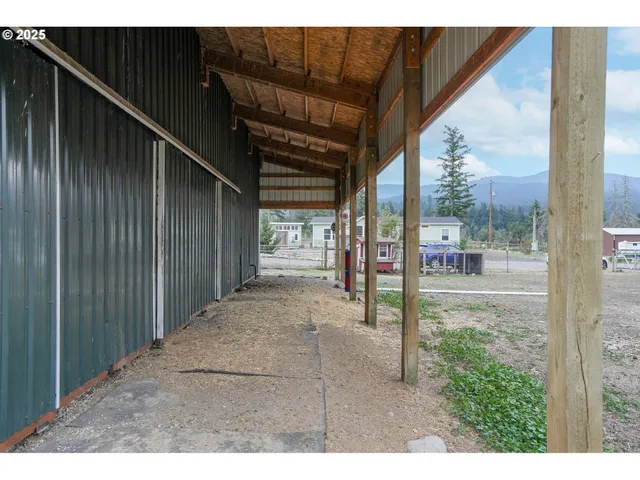 a view of a big house with a yard and sitting area
