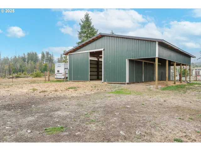 a view of a yard with a bench and trees