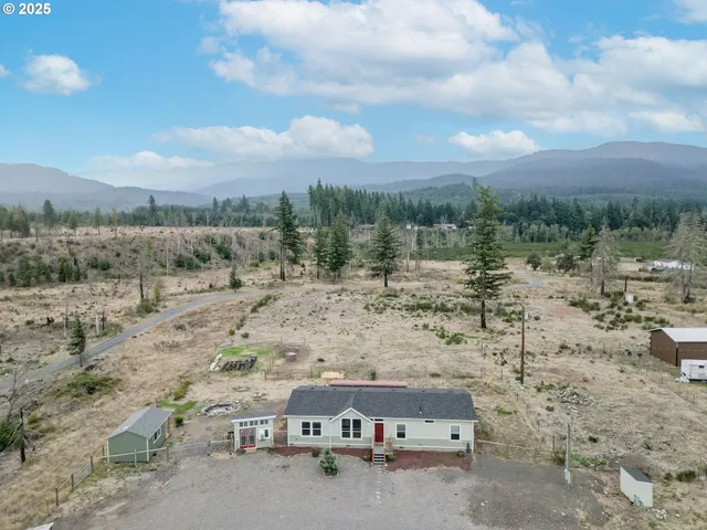 a view of a road with wooden fence