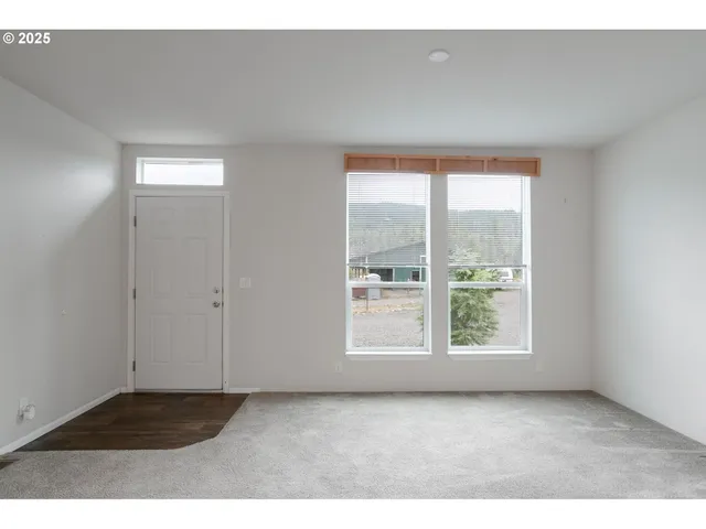 a kitchen with stainless steel appliances kitchen island granite countertop a refrigerator a stove top oven and a sink