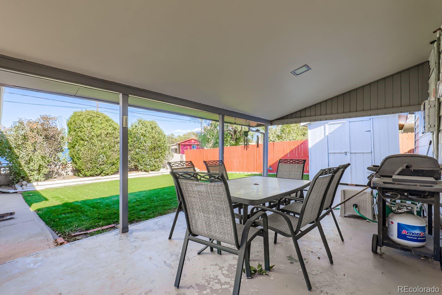 5441 East 67th Place Commerce City, CO 80022 - Photo 15 of 19 a dining room with furniture and a floor to ceiling window