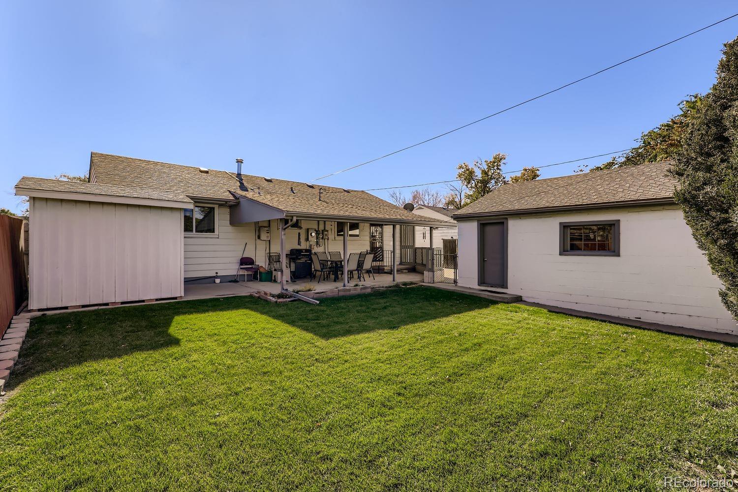 5441 East 67th Place Commerce City, CO 80022 - Photo 16 of 19 a view of a house with backyard and sitting area