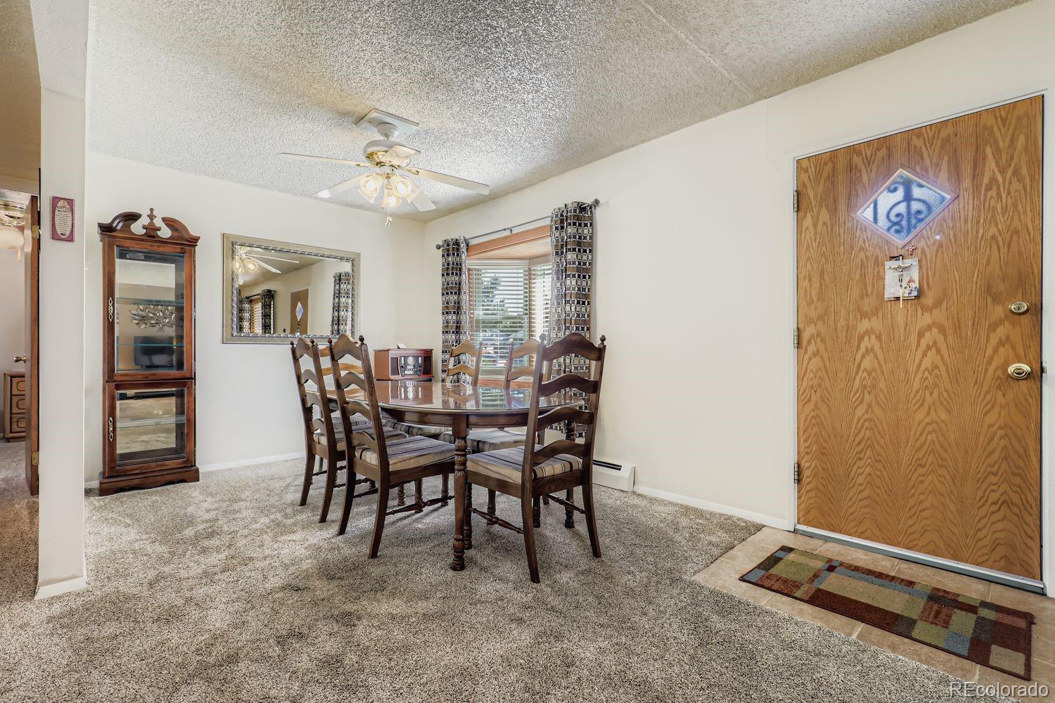5441 East 67th Place Commerce City, CO 80022 - Photo 7 of 19 a dining room with furniture and window