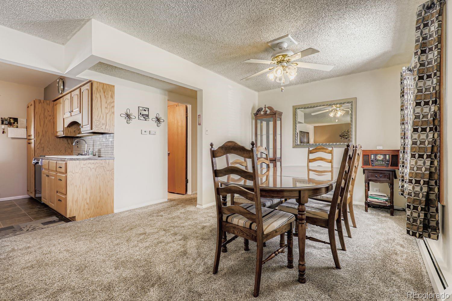 5441 East 67th Place Commerce City, CO 80022 - Photo 8 of 19 a view of a dining room with furniture and chandelier